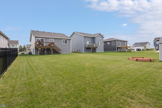 view of yard featuring central air condition unit, fence, stairway, a wooden deck, and a residential view