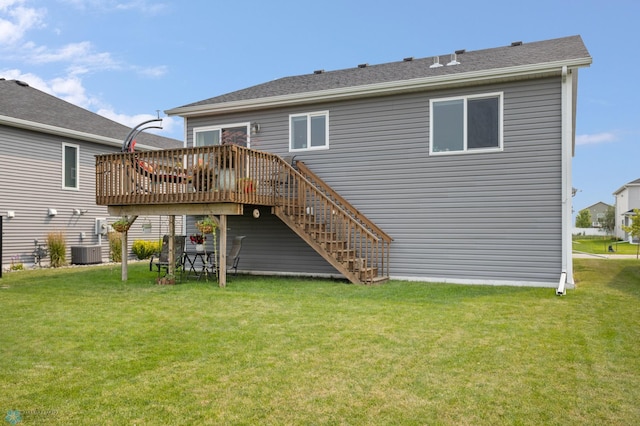 back of house featuring a lawn, a deck, and stairs