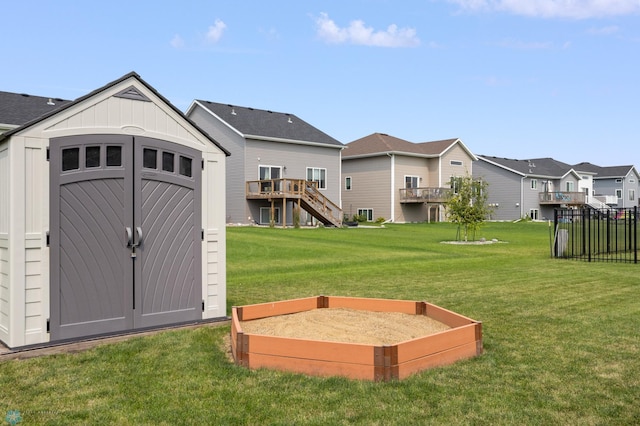 view of yard featuring stairs, a storage unit, an outdoor structure, and a residential view