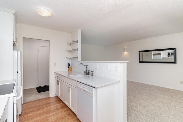 kitchen with white appliances, a sink, white cabinets, light countertops, and open shelves