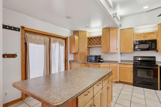 kitchen with light tile patterned floors, black appliances, light brown cabinetry, and a center island