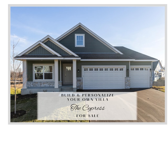 view of front of house featuring a garage, concrete driveway, and stone siding