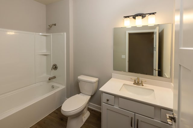 full bath featuring toilet, wood finished floors, vanity, baseboards, and shower / bathing tub combination