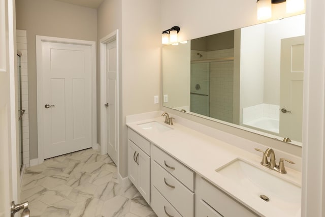 bathroom with a stall shower, marble finish floor, a sink, and double vanity