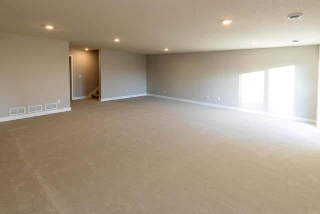 unfurnished room with baseboards, stairway, carpet, and recessed lighting