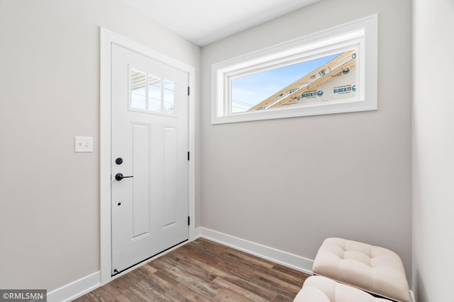 entryway with dark wood-style floors and baseboards