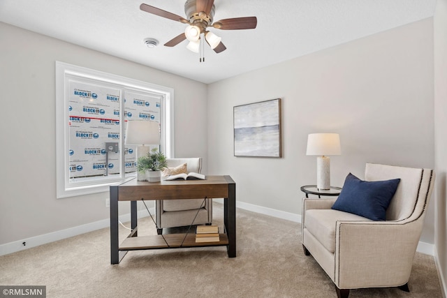 carpeted office space with ceiling fan and baseboards