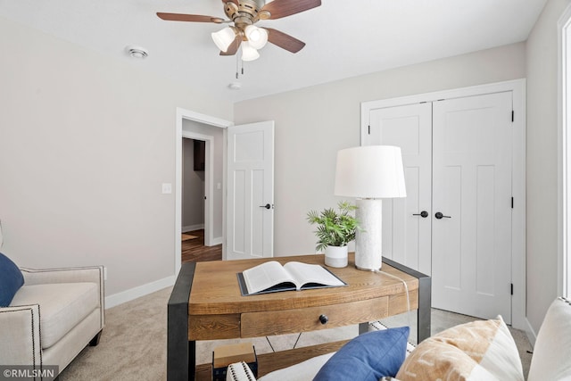 office area featuring a ceiling fan, light carpet, visible vents, and baseboards