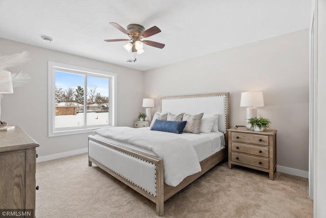 bedroom featuring a ceiling fan, light carpet, and baseboards