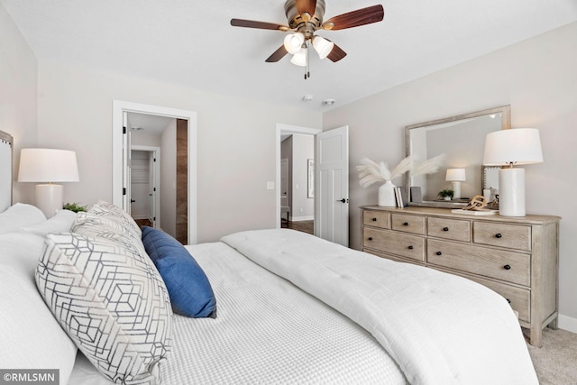 bedroom with a ceiling fan, light carpet, and baseboards