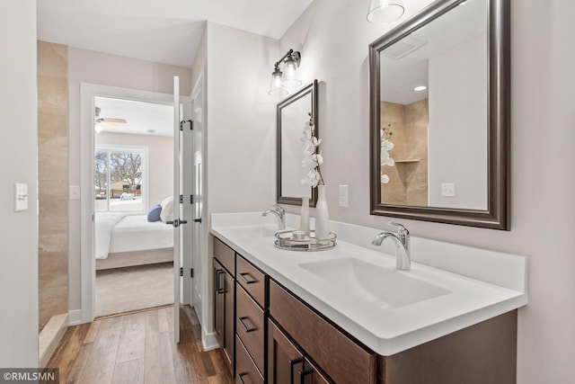 ensuite bathroom with wood finished floors, ensuite bath, a sink, and visible vents