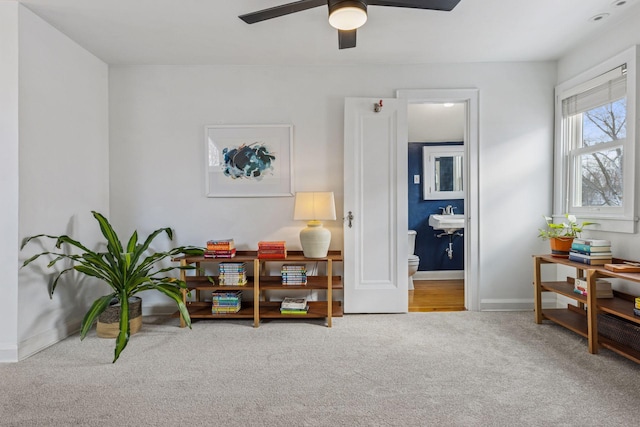 sitting room featuring carpet floors, ceiling fan, and baseboards