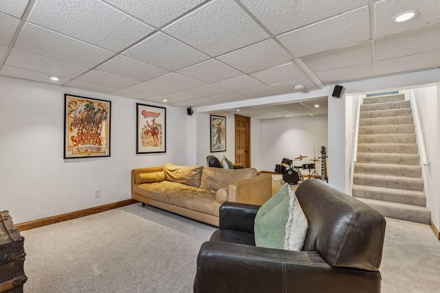 carpeted living area with a paneled ceiling, stairs, baseboards, and recessed lighting