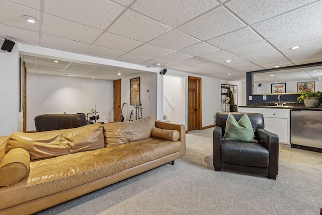 living area featuring a paneled ceiling, recessed lighting, light carpet, baseboards, and indoor wet bar