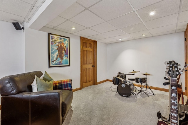 playroom with carpet floors, baseboards, and a paneled ceiling