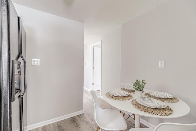 dining room with baseboards and wood finished floors