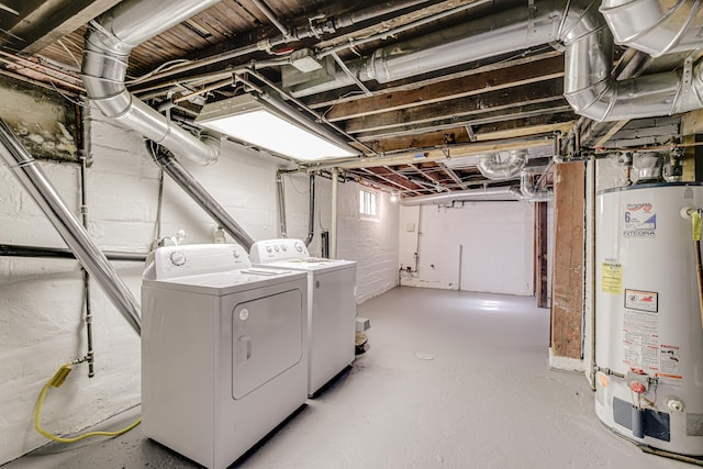 clothes washing area featuring laundry area, water heater, and washing machine and clothes dryer