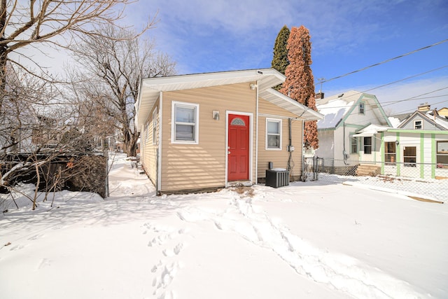 view of front of home with fence and central AC