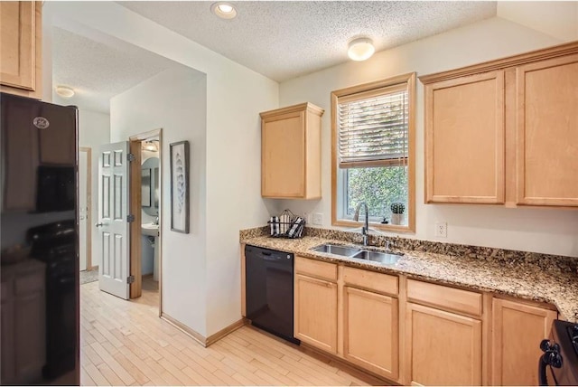 kitchen featuring stove, light brown cabinetry, a sink, a textured ceiling, and dishwasher