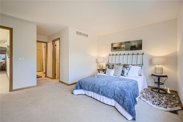 bedroom with carpet floors, baseboards, and visible vents