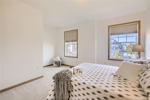 bedroom with carpet and baseboards