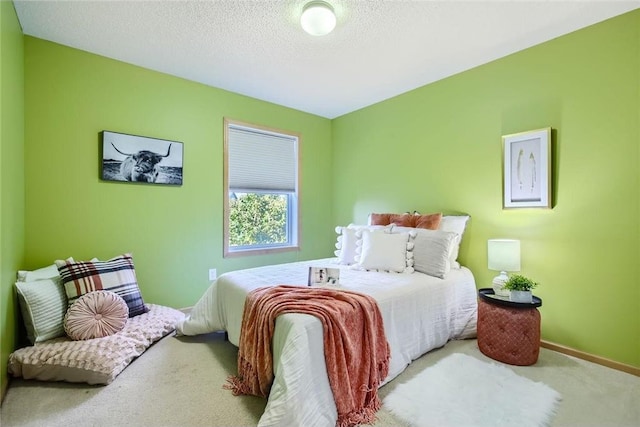 bedroom featuring a textured ceiling, carpet flooring, and baseboards