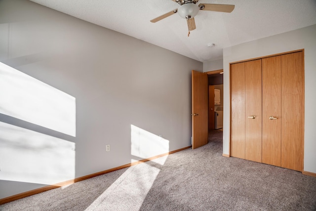 unfurnished bedroom featuring a ceiling fan, carpet, a closet, and baseboards