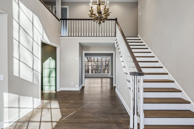 10 Saint Albans Rd E, Hopkins, MN 55305 - foyer entrance featuring a chandelier, stairs, wood finished floors, baseboards, and a high ceiling