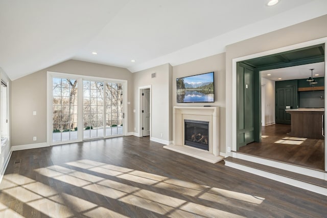 10 Saint Albans Rd E, Hopkins, MN 55305 - unfurnished living room with vaulted ceiling, a glass covered fireplace, dark wood-style floors, baseboards, and recessed lighting