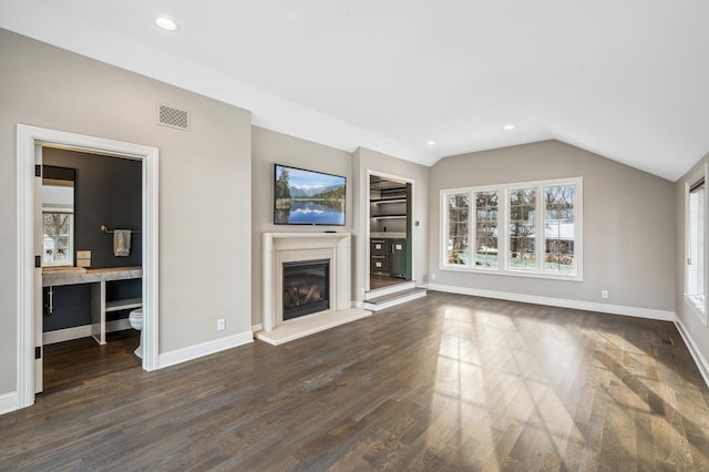10 Saint Albans Rd E, Hopkins, MN 55305 - unfurnished living room with a glass covered fireplace, lofted ceiling, baseboards, dark wood-type flooring, and recessed lighting