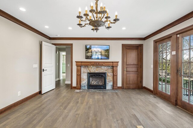 10 Saint Albans Rd E, Hopkins, MN 55305 - unfurnished living room with baseboards, ornamental molding, a fireplace, wood finished floors, and a chandelier