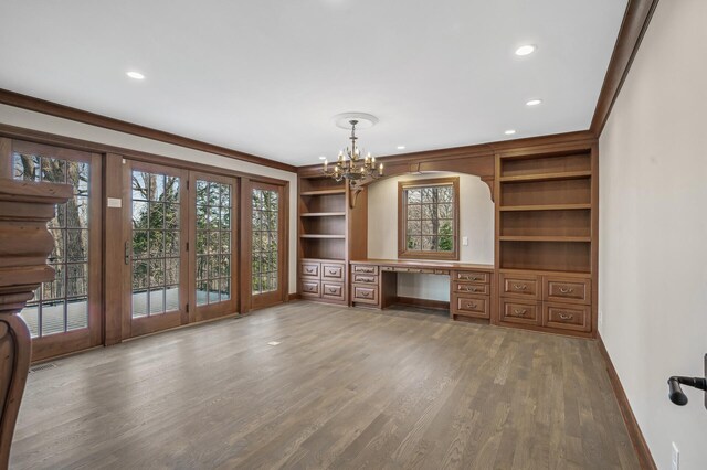 10 Saint Albans Rd E, Hopkins, MN 55305 - unfurnished office with built in desk, wood finished floors, a chandelier, plenty of natural light, and ornamental molding