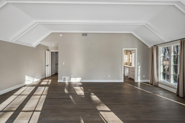 10 Saint Albans Rd E, Hopkins, MN 55305 - unfurnished living room with lofted ceiling, baseboards, and dark wood-style floors