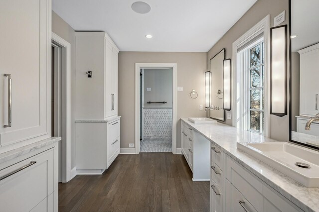10 Saint Albans Rd E, Hopkins, MN 55305 - bathroom with wood finished floors, double vanity, baseboards, and recessed lighting