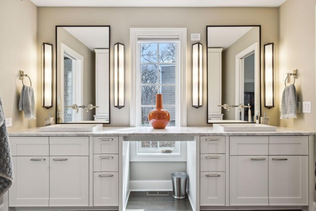 10 Saint Albans Rd E, Hopkins, MN 55305 - bathroom featuring two vanities and baseboards