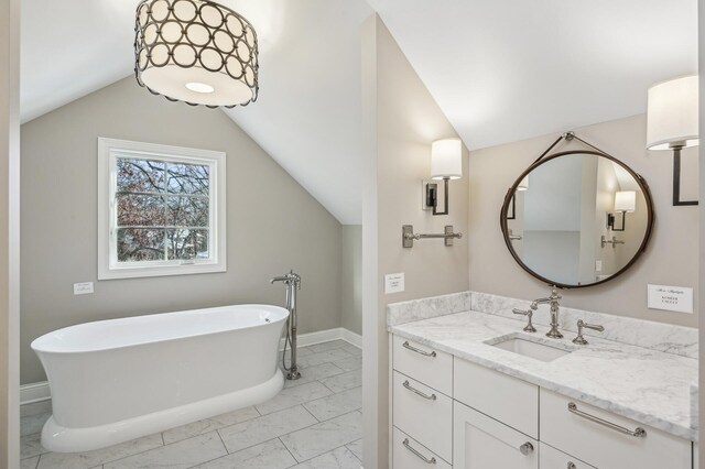10 Saint Albans Rd E, Hopkins, MN 55305 - full bath with marble look tile flooring, vaulted ceiling, vanity, a freestanding bath, and baseboards