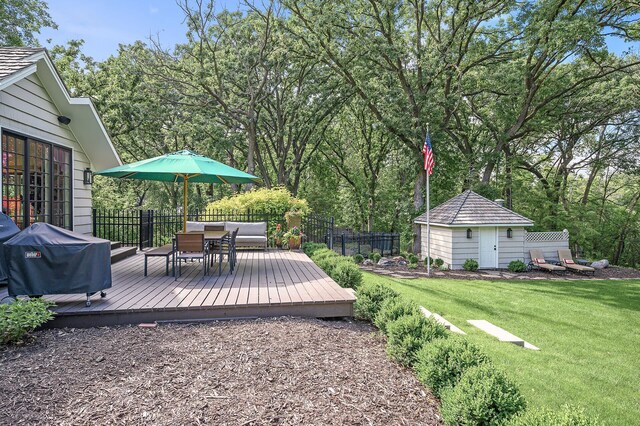 10 Saint Albans Rd E, Hopkins, MN 55305 - view of yard featuring an outdoor structure, outdoor dining area, a wooden deck, and a shed