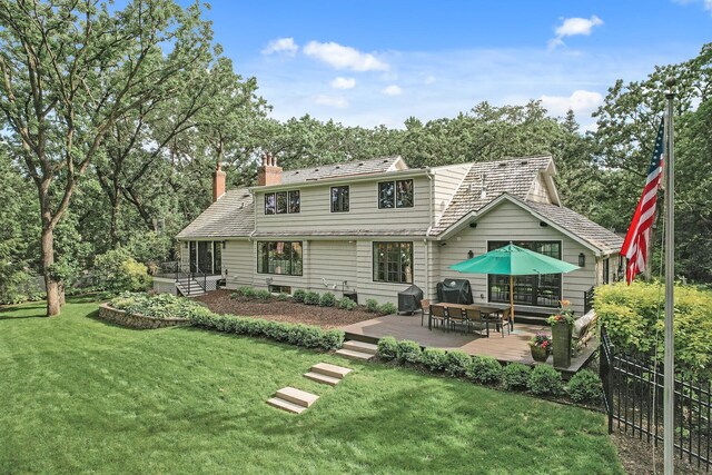 10 Saint Albans Rd E, Hopkins, MN 55305 - rear view of property with a wooden deck, a chimney, and a yard