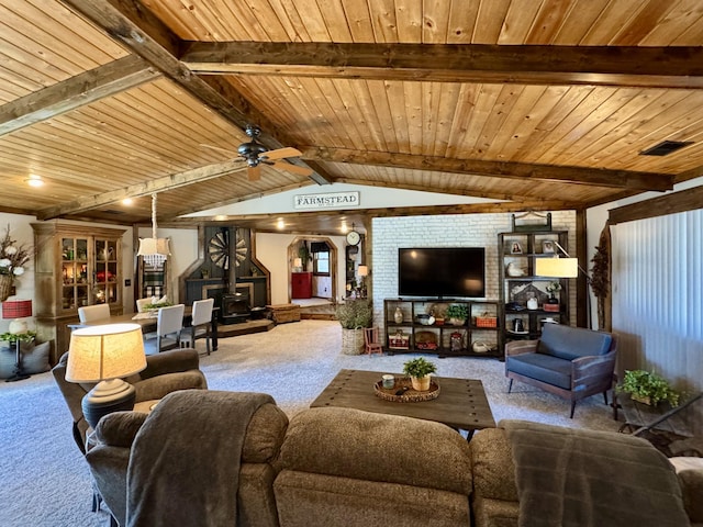 living room with vaulted ceiling with beams, ceiling fan, carpet, and wooden ceiling