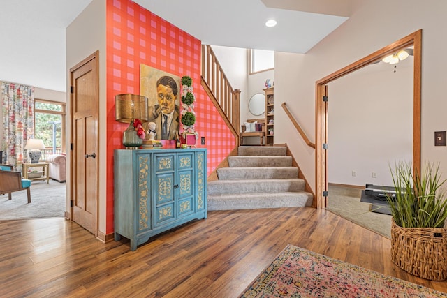 stairs with recessed lighting, baseboards, wallpapered walls, and wood finished floors
