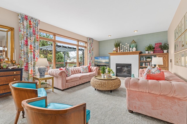 carpeted living room with a glass covered fireplace
