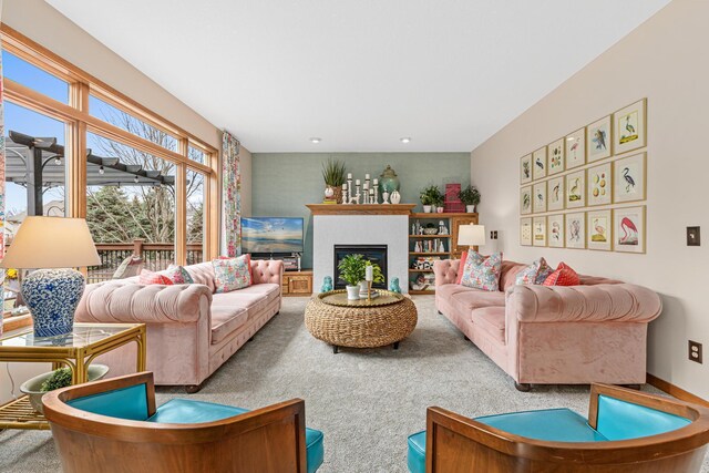 living area featuring carpet flooring and a fireplace