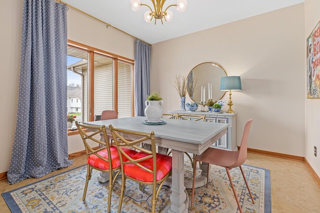 dining area featuring an inviting chandelier and baseboards