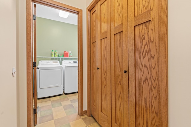 clothes washing area featuring washer and dryer, laundry area, and light floors