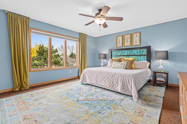 carpeted bedroom with a ceiling fan and baseboards
