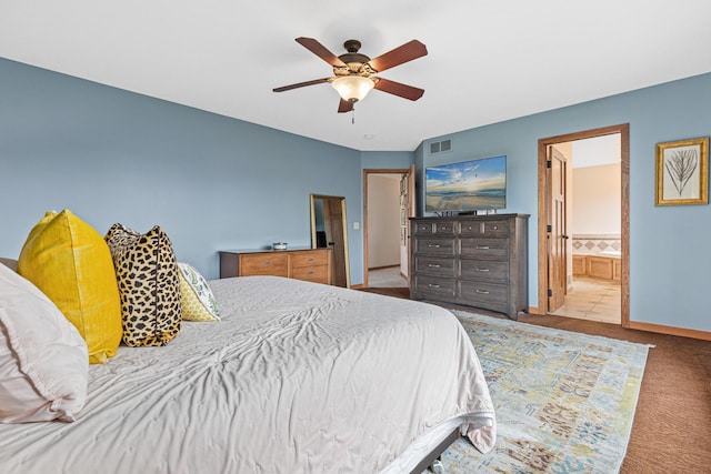 bedroom featuring visible vents, carpet floors, baseboards, connected bathroom, and a ceiling fan