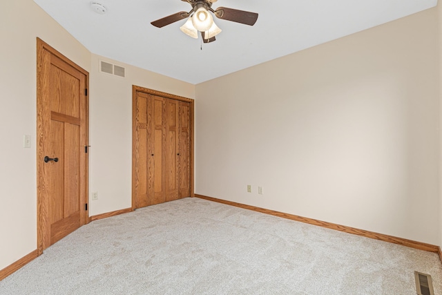 unfurnished bedroom featuring visible vents, baseboards, carpet floors, and a closet