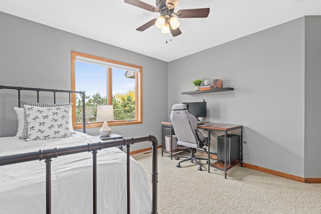 carpeted bedroom featuring baseboards and ceiling fan