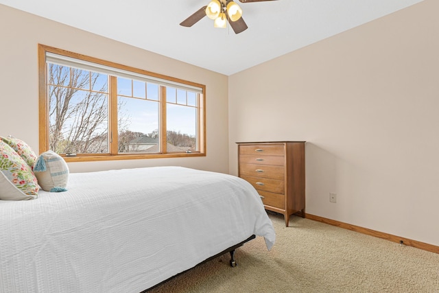 bedroom with baseboards, ceiling fan, and light carpet