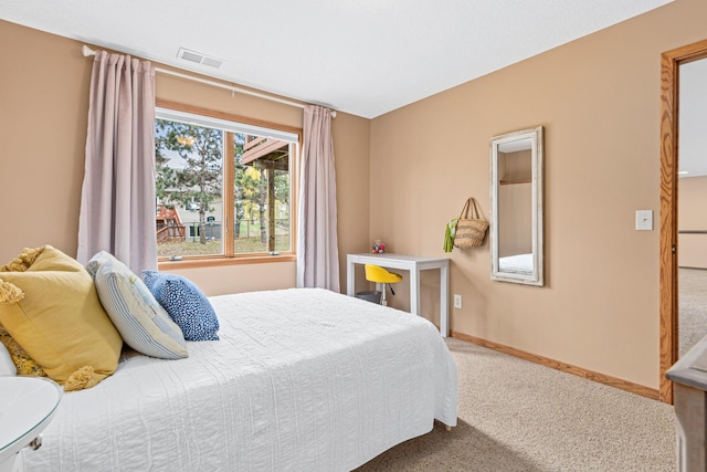 carpeted bedroom with baseboards and visible vents